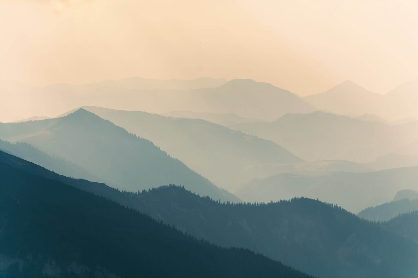 aerial photograph of a mountain covered with fogs